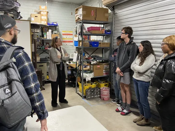 Students listening to presentation in warehouse