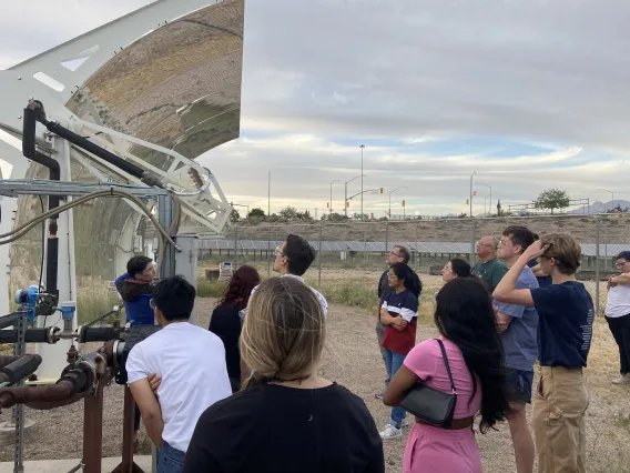 Students viewing concentrated solar-power collection system