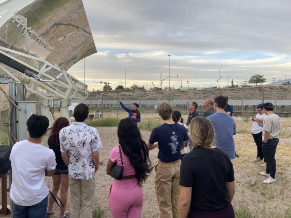 students listening to teacher explain solar-powered system