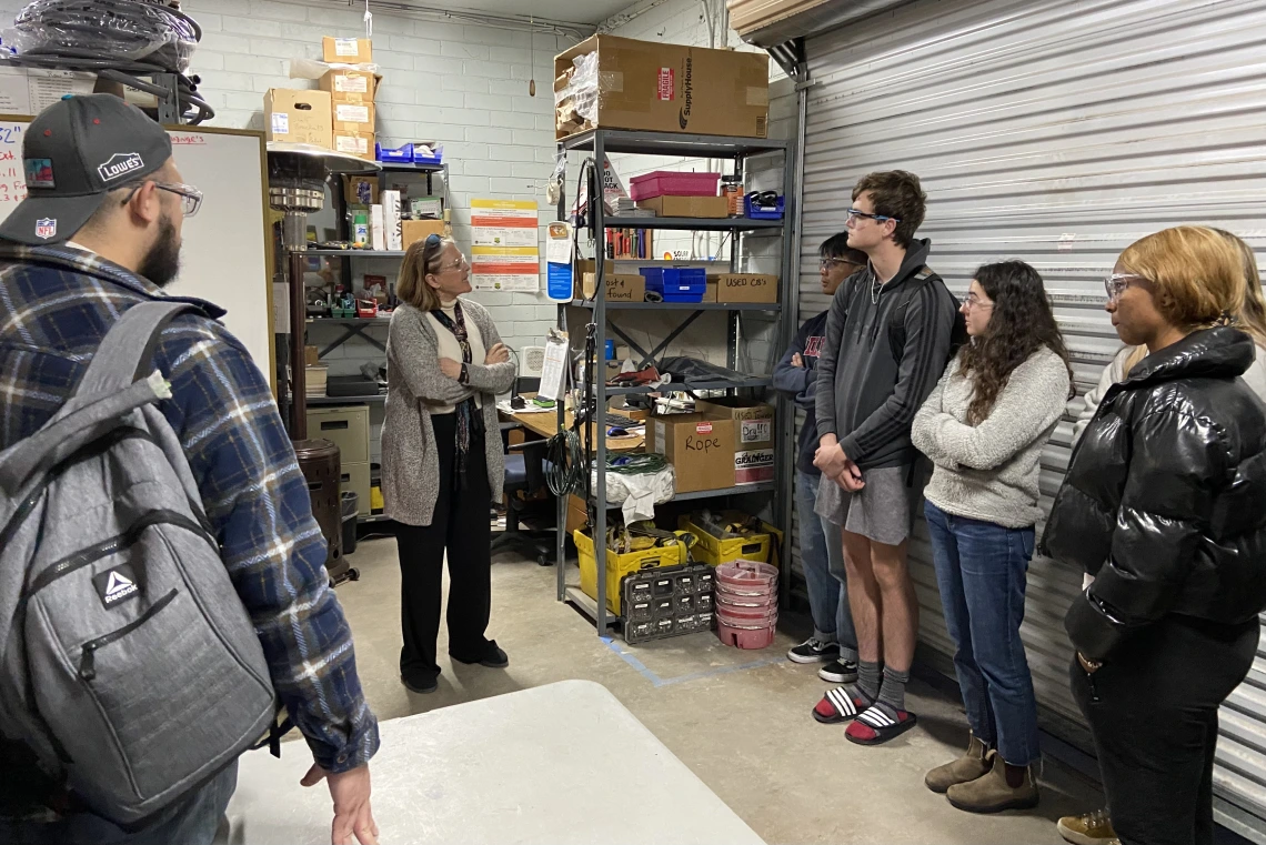 Students listening to presentation in warehouse