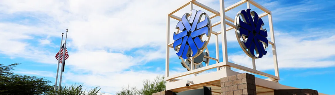 Pima Community college logo on a building rooftop